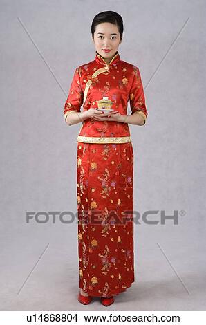Young women in cheongsam holding tea cup View Large Photo Image Picture - Young women in cheongsam holding tea cup. Fotosearch