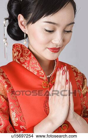 Young women in cheongsam praying View Large Photo Image Picture - Young women in cheongsam praying. Fotosearch