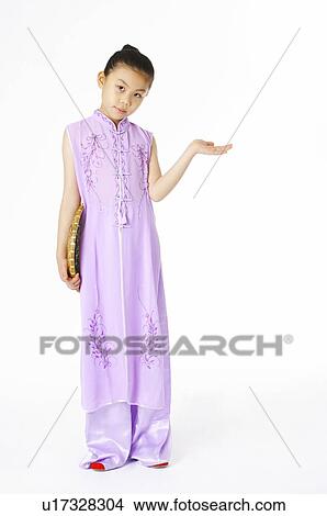 Girl in Chinese traditional dress holding the dustpan View Large Photo Image Picture - Girl in Chinese traditional dress holding the dustpan. Fotosearch