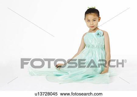Girl in green skirt sitting on the floor View Large Photo Image Stock Photography - Girl in green skirt sitting on the floor. Fotosearch