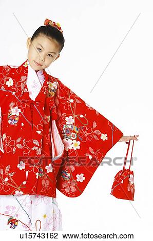Stock Image - Girl in kimono holding a bag. Fotosearch