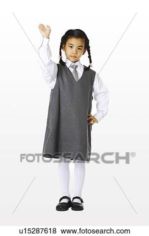 Stock Photo - Girl in school uniforms raise her hand. Fotosearch