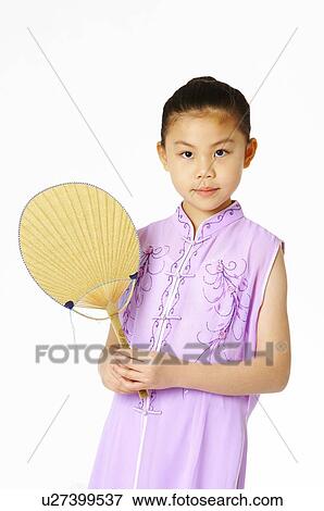Stock Photo - Girl in traditional dress hold a fan. Fotosearch