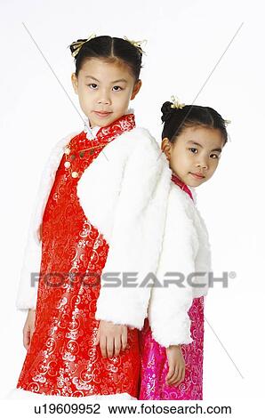 Girls in Chinese traditional dress back-to-back View Large Photo Image Stock Image - Girls in Chinese traditional dress back-to-back. Fotosearch