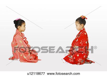 Girls in kimono sitting face to face View Large Photo Image Stock Photo - Girls in kimono sitting face to face. Fotosearch