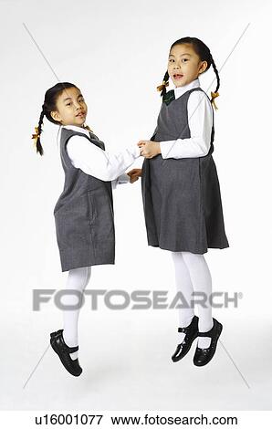Girls in school uniform, hand in hand View Large Photo Image Stock Photo - Girls in school uniform, hand in hand. Fotosearch