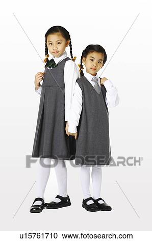 Girls in school uniforms hand in hand View Large Photo Image Stock Image - Girls in school uniforms hand in hand. Fotosearch
