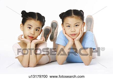 Stock Image - Girls putting their face between hands. Fotosearch