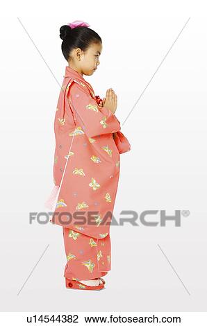 Stock Image - The side of a girl in kimono. Fotosearch