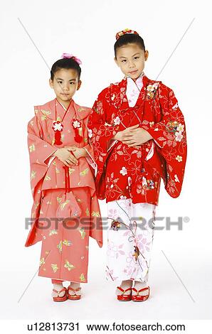 Two girls in kimono putting their hands on stomach View Large Photo Image Stock Image - Two girls in kimono putting their hands on stomach. Fotosearch