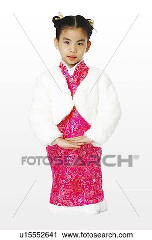 Stock Image - Young girl wearing traditional Chinese clothing, crouching. Fotosearch