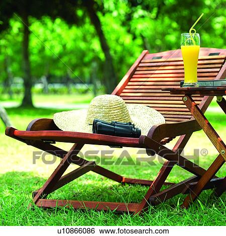 Stock Photograph - Couches, Telescope, Trees, Notebook, Notebooks, Straw, Orance juice. Fotosearch