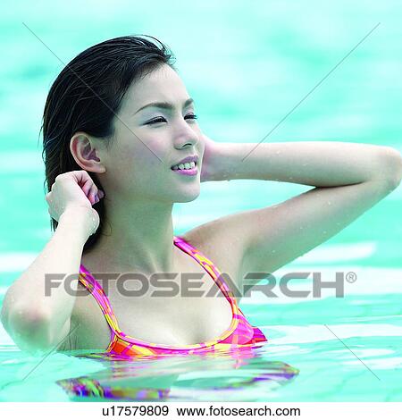 Stock Photo - Female, Swimsuit, Water, Pool, Beautiful woman, Women, People. Fotosearch
