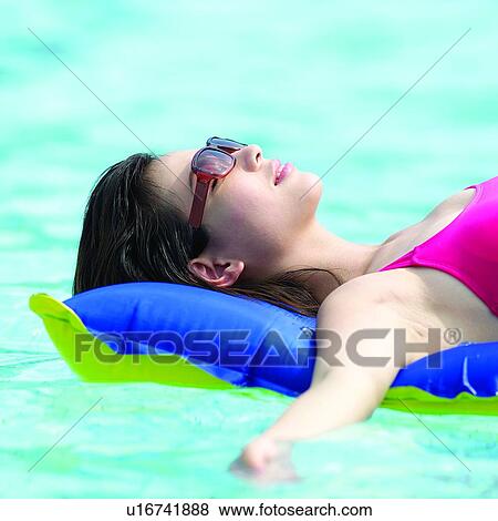 Summer Splash, Woman, Swimsuit, Oriental female, Beautiful woman, Air-cushions, Pool View Large Photo Image Stock Photo - Summer Splash, Woman, Swimsuit, Oriental female, Beautiful woman, Air-cushions, Pool. Fotosearch