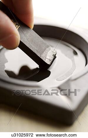 Stock Image - Grinding ink stick. Fotosearch