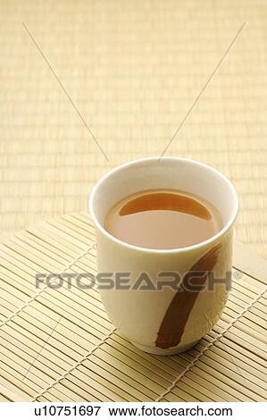 Stock Photo - Teacup on a bamboo curtain. Fotosearch