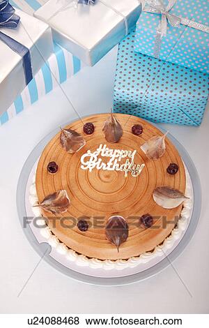 Stock Photo - Birthday cake and wrapped gifts. Fotosearch