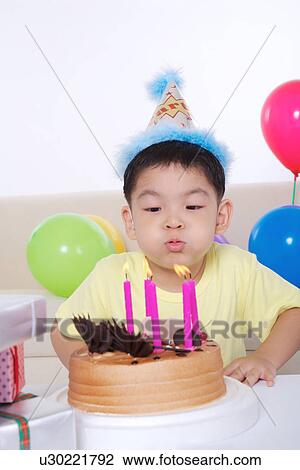 Boy blowing birthday candles View Large Photo Image Stock Image - Boy blowing birthday candles. Fotosearch