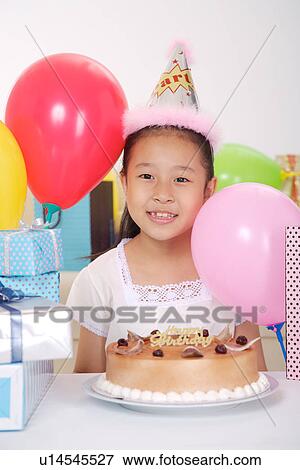 Stock Photo - Girl at birthday party. Fotosearch