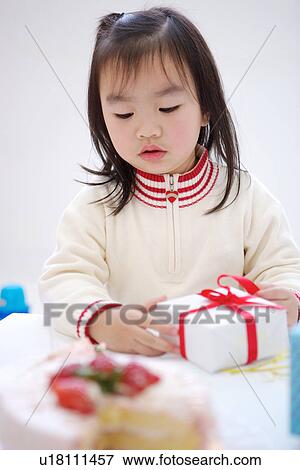 Stock Photo - Girl at birthday party. Fotosearch