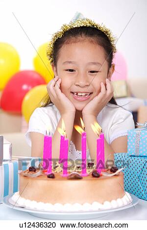 Girl at birthday party, wearing party hat View Large Photo Image Stock Image - Girl at birthday party, wearing party hat . Fotosearch