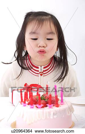 Picture - Girl browing birthday cake. Fotosearch
