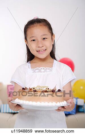 Girl holding birthday cake, smiling, portrait View Large Photo Image Stock Photo - Girl holding birthday cake, smiling, portrait. Fotosearch