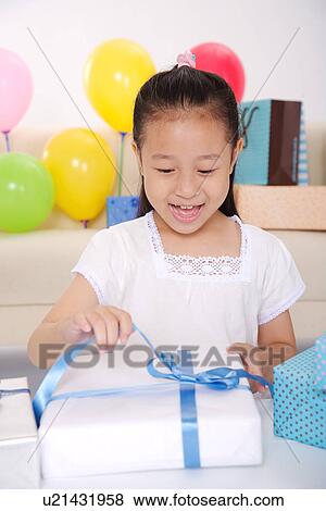 Girl opening gift, smiling, portrait View Large Photo Image Stock Photo - Girl opening gift, smiling, portrait. Fotosearch