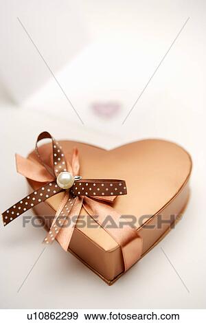 Heart shaped box with brown bow, elevated view View Large Photo Image Stock Photo - Heart shaped box with brown bow, elevated view . Fotosearch