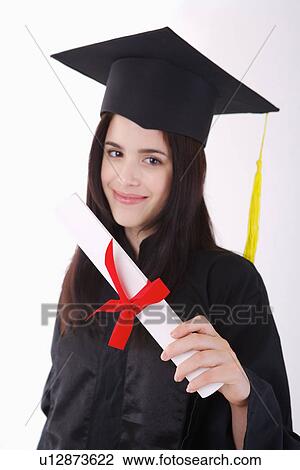 One single woman wearing graduation gown holding certificate, smiling, portrait View Large Photo Image Stock Image - One single woman wearing graduation gown holding certificate, smiling, portrait. Fotosearch