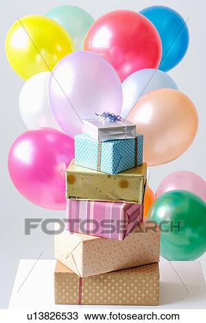 Stock Image - Stacked gifts and balloons. Fotosearch