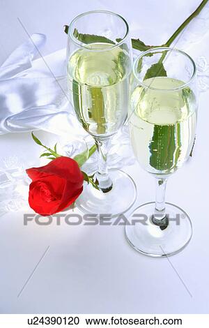 Stock Image - Wineglasses with beer and single rose. Fotosearch
