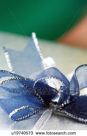 Wrapped gift with blue ribbon bow View Large Photo Image Stock Image - Wrapped gift with blue ribbon bow. Fotosearch