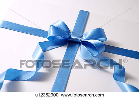 Stock Image - Wrapped gift with blue ribbon. Fotosearch
