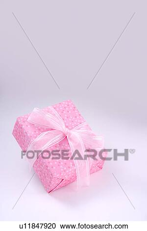 Stock Image - Wrapped gift with pink ribbon. Fotosearch