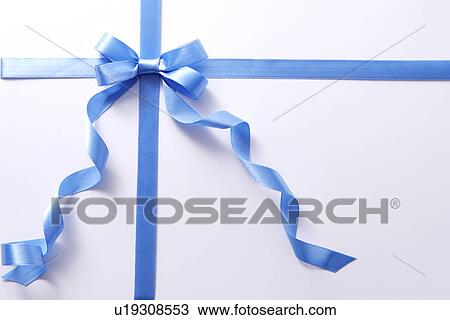 Stock Image - Wrapped present with blue ribbon, overhead view, full frame. Fotosearch