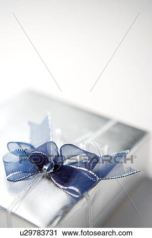 Stock Image - Wrapped present with ribbon, overhead view . Fotosearch