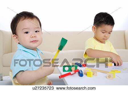 Baby boy and boy playing block View Large Photo Image Stock Image - Baby boy and boy playing block. Fotosearch