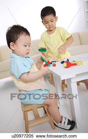 Stock Photography - Baby boy and boy playing block. Fotosearch