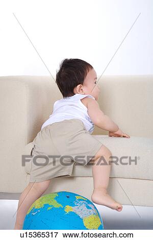 Baby boy crawling toward sofa View Large Photo Image Stock Photo - Baby boy crawling toward sofa. Fotosearch