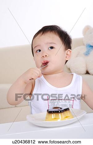 Baby boy putting spoon into mouth View Large Photo Image Stock Image - Baby boy putting spoon into mouth. Fotosearch