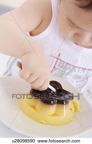 Stock Image - Baby boy with cake. Fotosearch