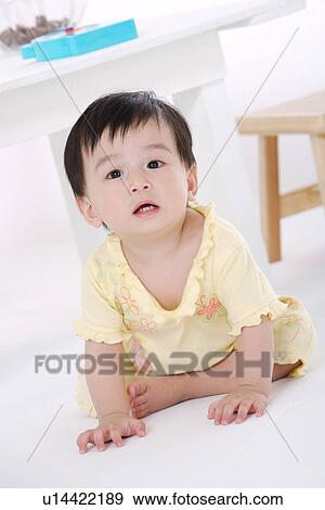 Baby girl sitting on floor View Large Photo Image Stock Photo - Baby girl sitting on floor. Fotosearch