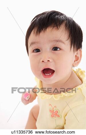 Stock Photograph - Baby girl smiling, close up, portrait. Fotosearch