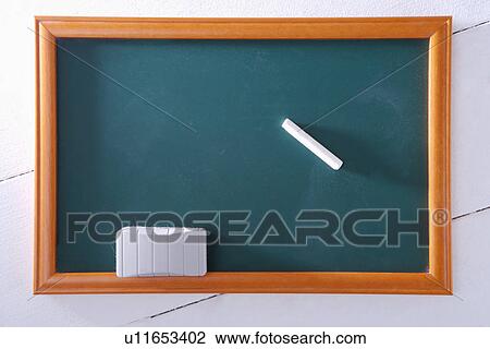 Stock Image - Blackboard with chalk and eraser. Fotosearch