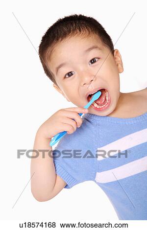 Stock Photo - Boy brushing teeth, portrait. Fotosearch
