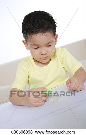 Boy drawing on paper View Large Photo Image Stock Photo - Boy drawing on paper. Fotosearch