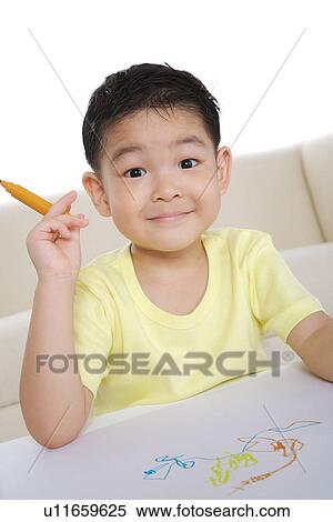 Boy drawing on paper View Large Photo Image Stock Photography - Boy drawing on paper. Fotosearch