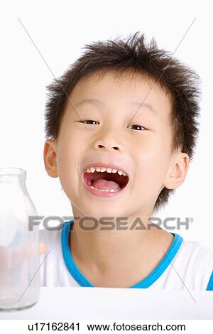 Stock Image - Boy smiling with mouth open, close up, portrait. Fotosearch