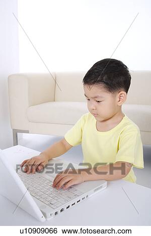 Boy using laptop, portrait View Large Photo Image Stock Photograph - Boy using laptop, portrait. Fotosearch